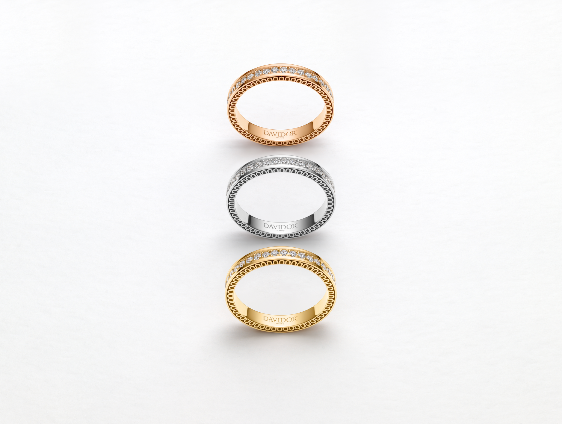 A thin silver bangle bracelet featuring a repeating arch design along its outer edge, displayed against a plain white background.