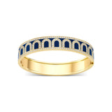 The L'Arc de DAVIDOR Bangle GM is handcrafted in 18k yellow gold, featuring blue lacquered ceramic arches bordered by sparkling Palais diamonds along the top and bottom edges.