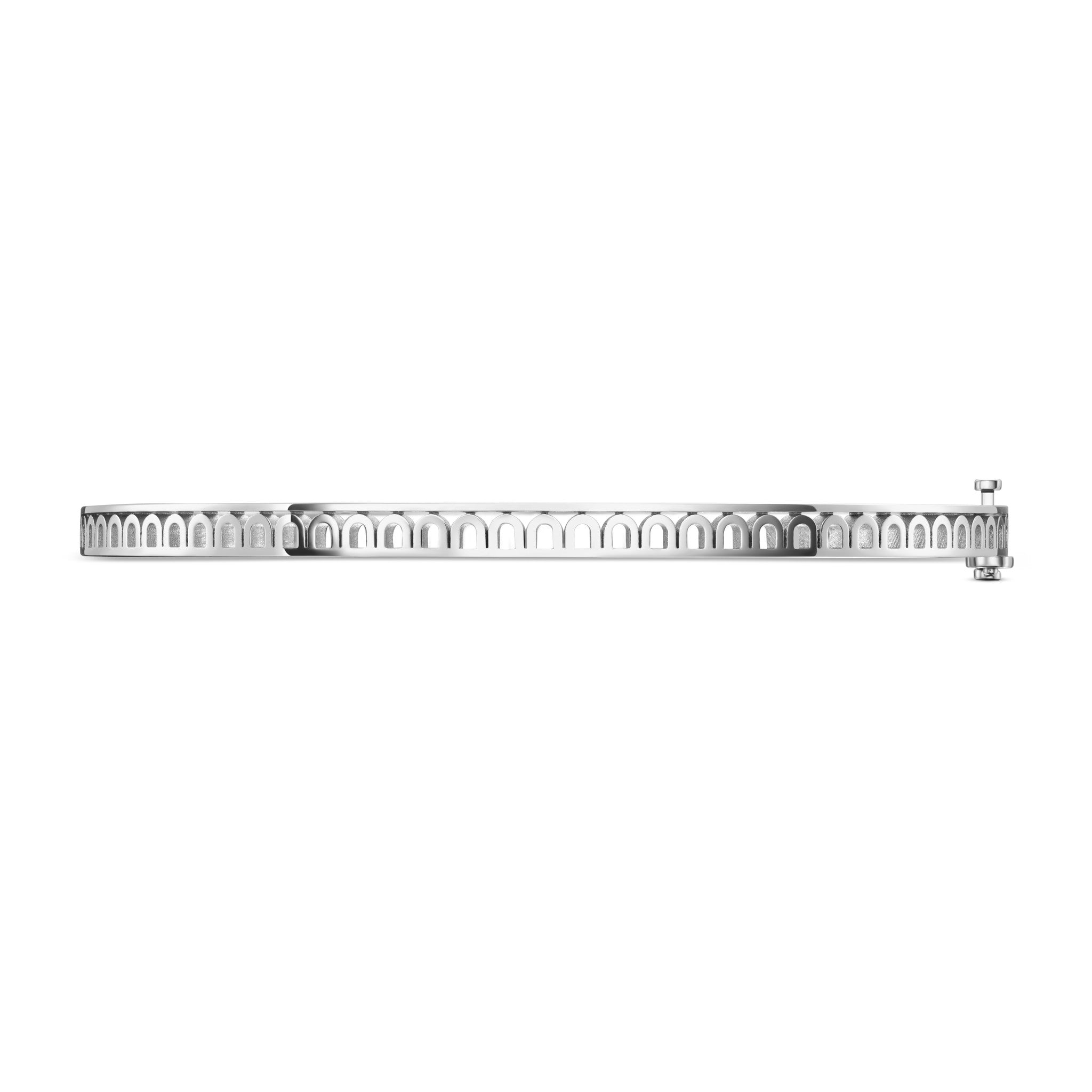 A thin, silver L’Arc Treille Bangle Mini, 18k White Gold, features repeating arch-shaped cutouts and a small round clasp on the right side, perfect for stacking and shown against a plain white background.