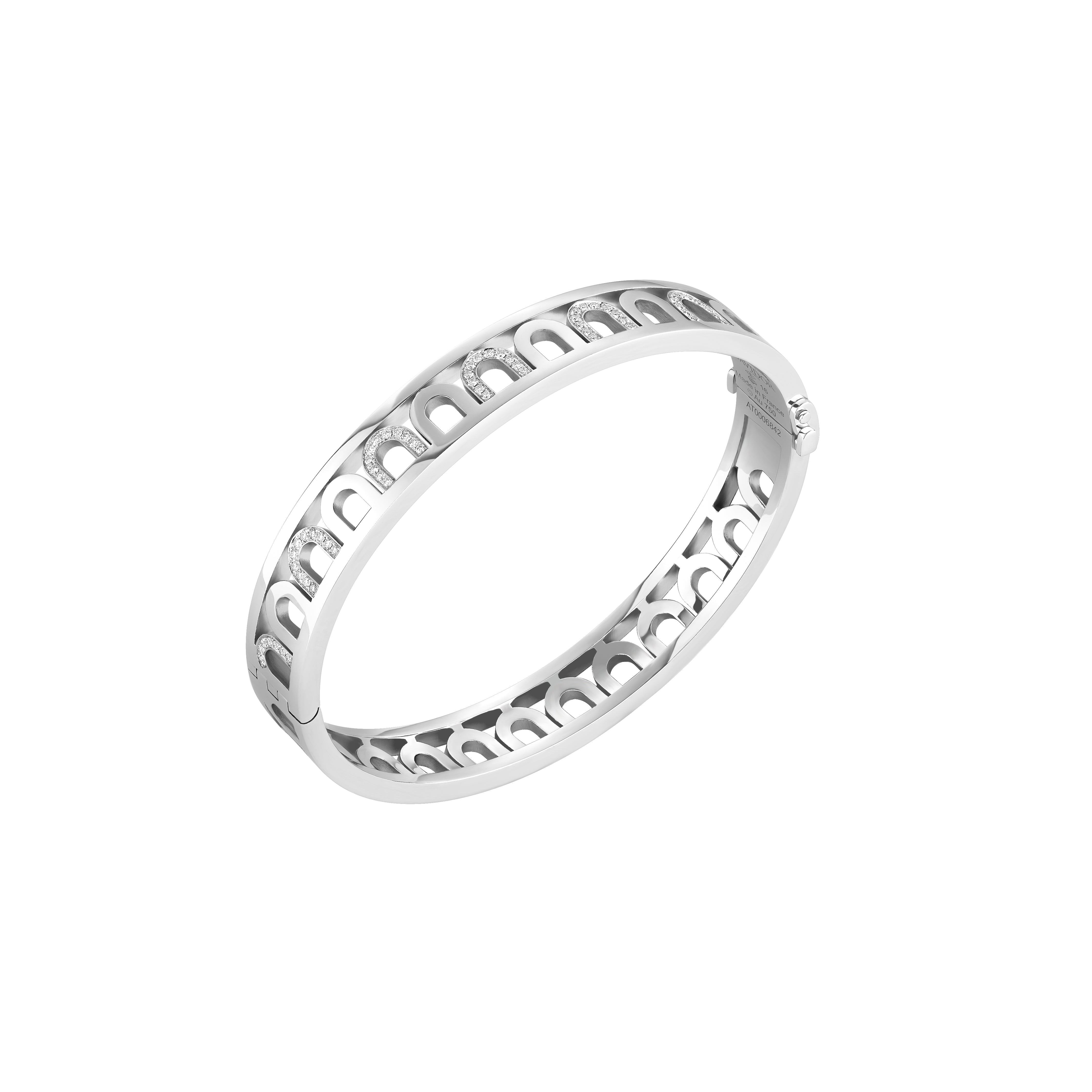 The L'Arc Treille Bangle MM features 18k white gold, an open geometric design, and evenly spaced Colonnato diamonds across the top. Its polished finish highlights the bracelet’s modern elegance.