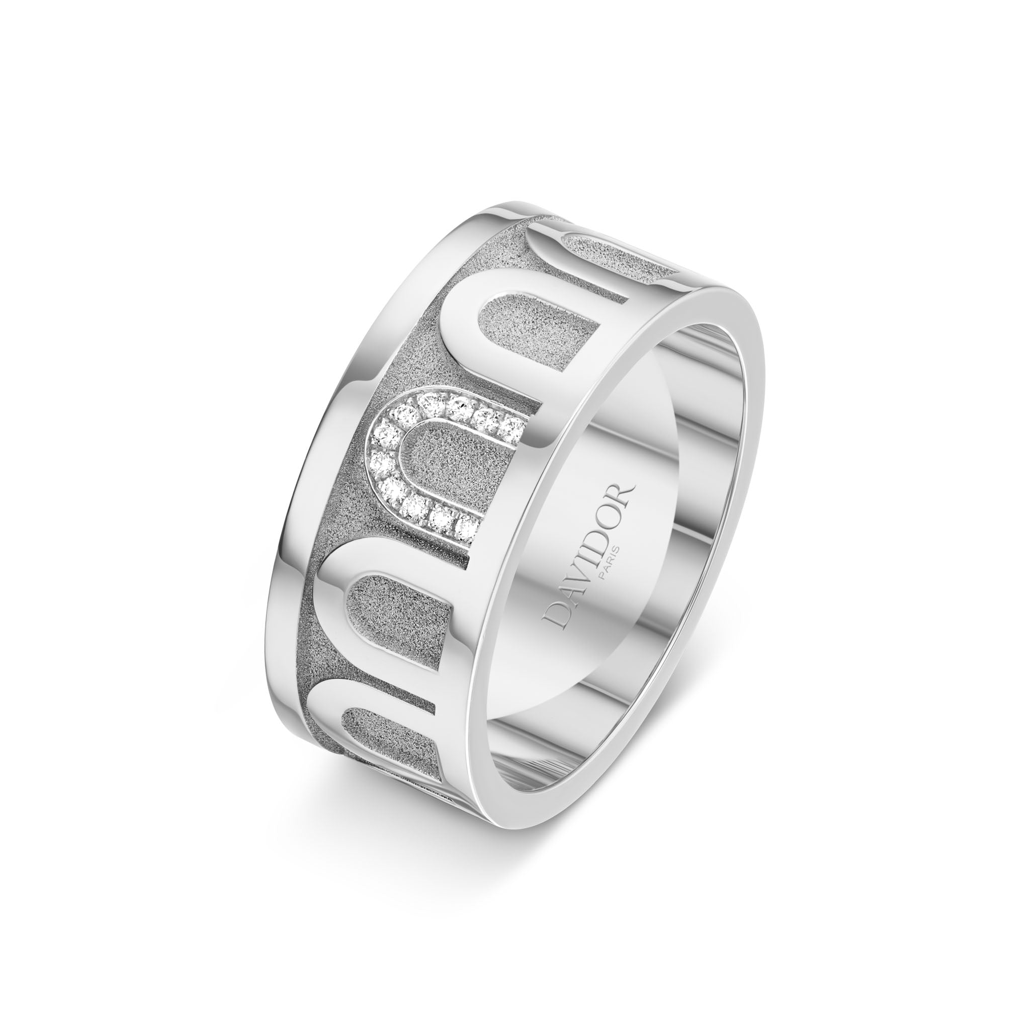 L’Arc de DAVIDOR Ring GM is a wide 18k white gold ring with a satin finish and geometric cutouts, featuring a row of Porta Simple diamonds set in one section. Expertly crafted as a stackable diamond ring, the inside of the band is engraved with the word DAVIDOR.
