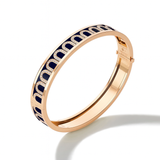 The L'Arc de DAVIDOR Bangle MM, crafted in 18k rose gold, features a repeating arched motif in lacquered ceramic and Arcade Diamonds, creating a striking design against a white background.