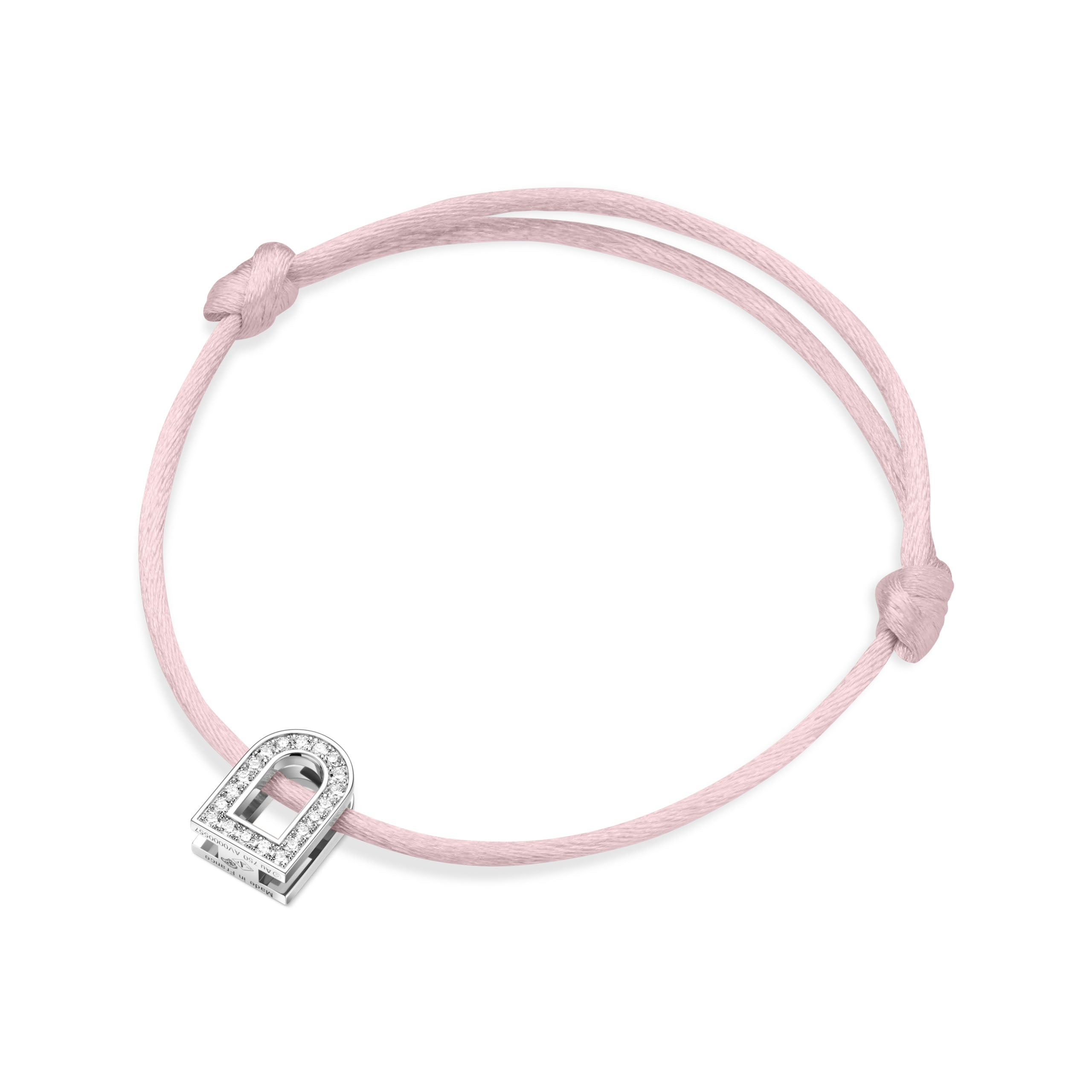 The L'Arc Voyage Charm PM bracelet from the Paris Atelier showcases a delicate silk cord in pink and a white gold charm adorned with Galerie diamonds. The bracelet features adjustable knots, offering a simple and elegant design.