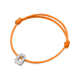 The L'Arc Voyage Charm PM bracelet, crafted in the Paris Atelier, features an exquisite 18k white gold charm adorned with Galerie diamonds on an adjustable orange silk cord.