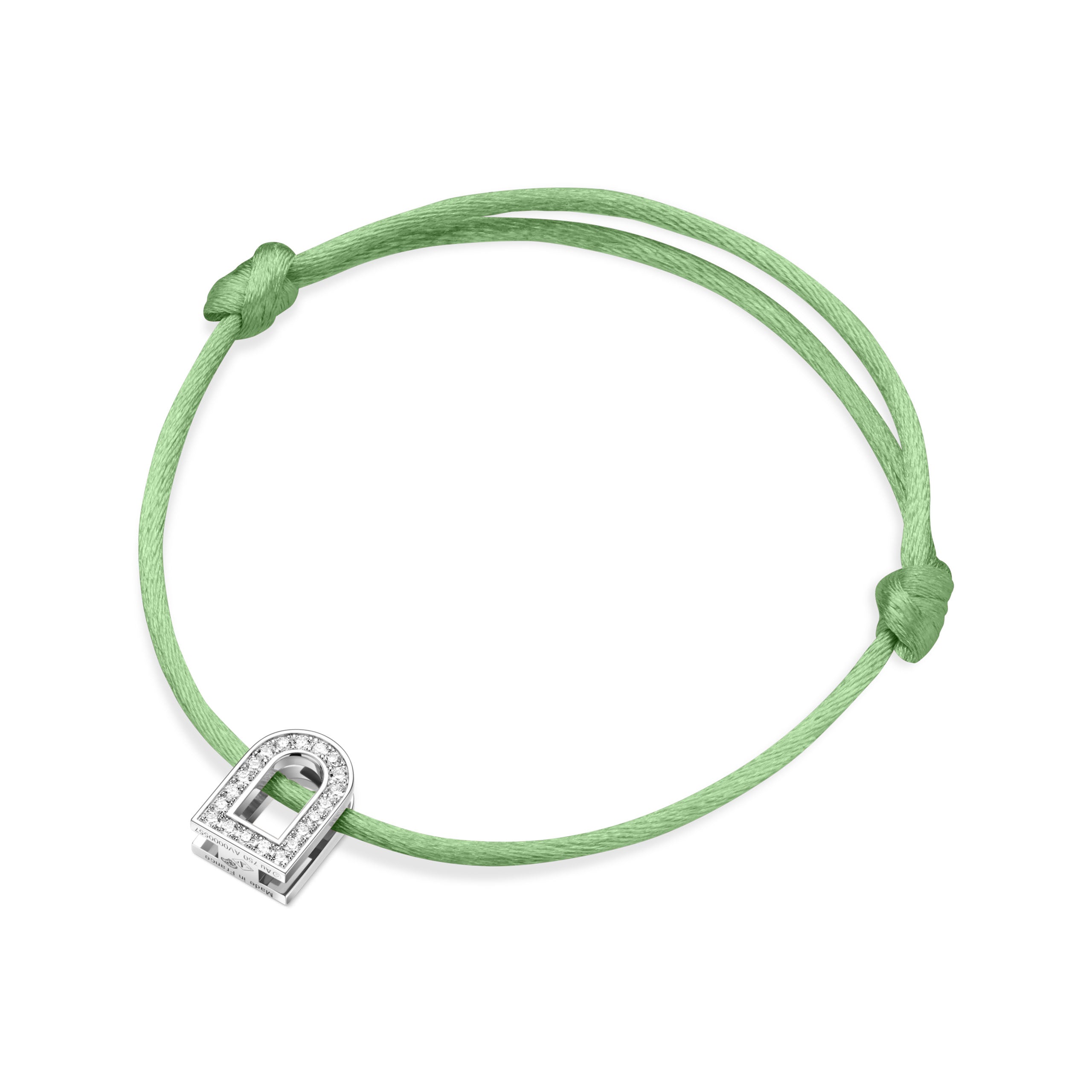 The L'Arc Voyage Charm PM bracelet, crafted with 18k white gold and Galerie diamonds, is a delicate piece featuring a green silk cord and an elegantly designed horseshoe charm, reminiscent of the exquisite craftsmanship found in a Paris atelier.