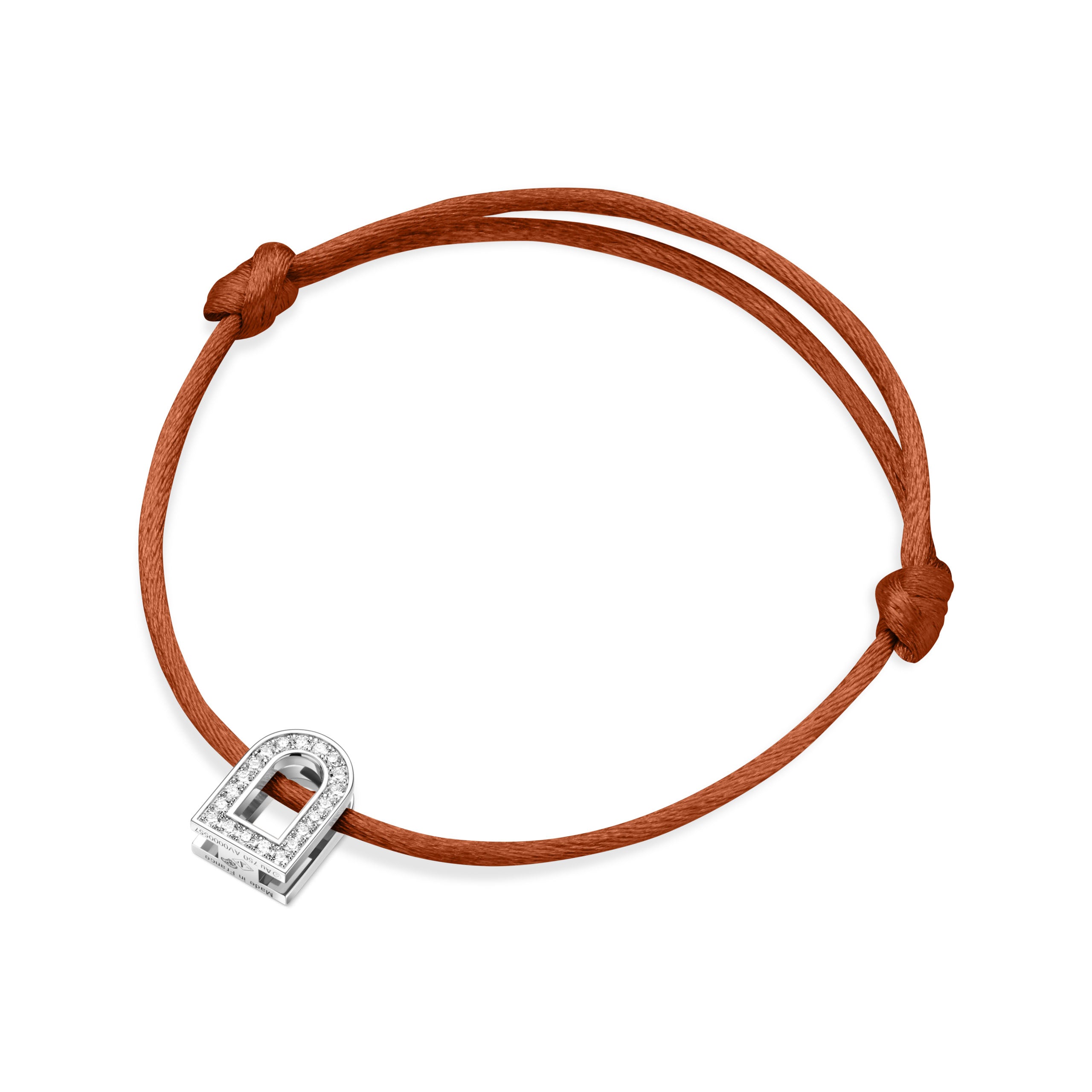 Introducing the L'Arc Voyage Charm PM, a timeless silk cord bracelet in rich brown, featuring an 18k white gold lock-shaped charm embellished with Galerie diamonds. This exquisite piece is meticulously crafted in our Paris Atelier and designed with adjustable knots for the perfect fit.