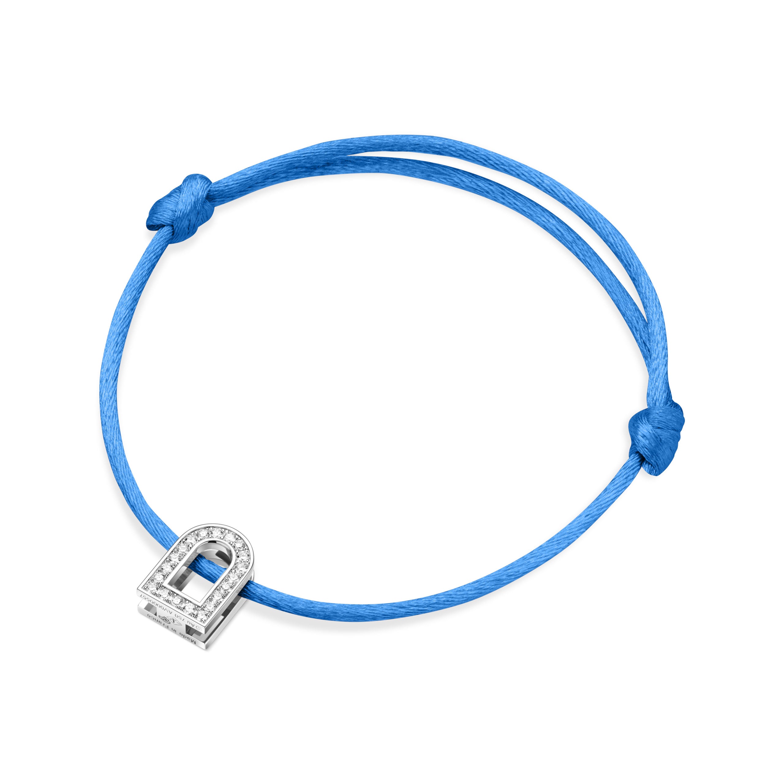 The L'Arc Voyage Charm PM bracelet, crafted with 18k white gold and embellished with Galerie diamonds, captures the elegance of a Paris atelier. The bracelet is fastened with simple knots on a blue silk cord and set against a plain white background.