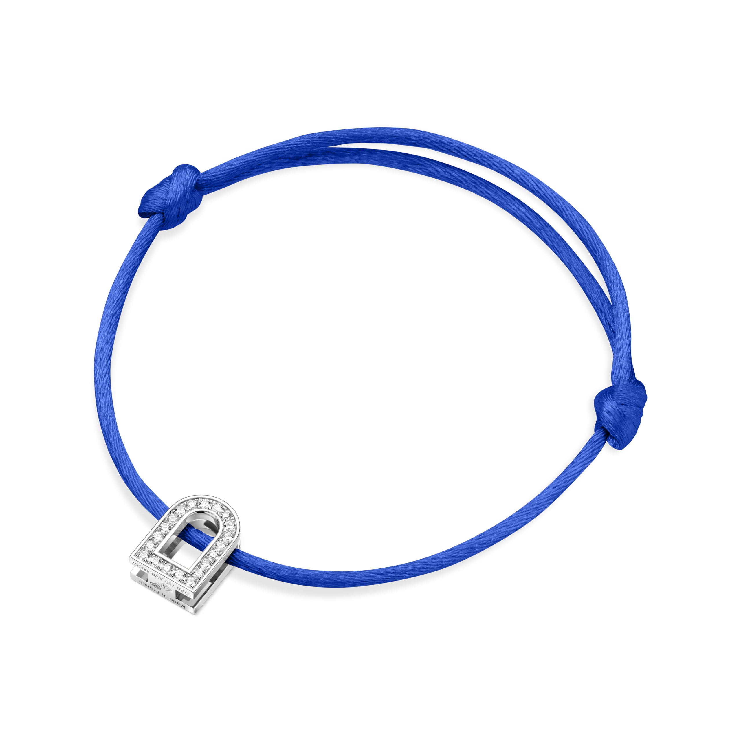 A silk cord bracelet in blue, showcasing the L'Arc Voyage Charm PM, crafted from 18k white gold and adorned with Galerie diamonds, reminiscent of a Paris Atelier creation. The cord elegantly loops with knots at each end against a plain white background.