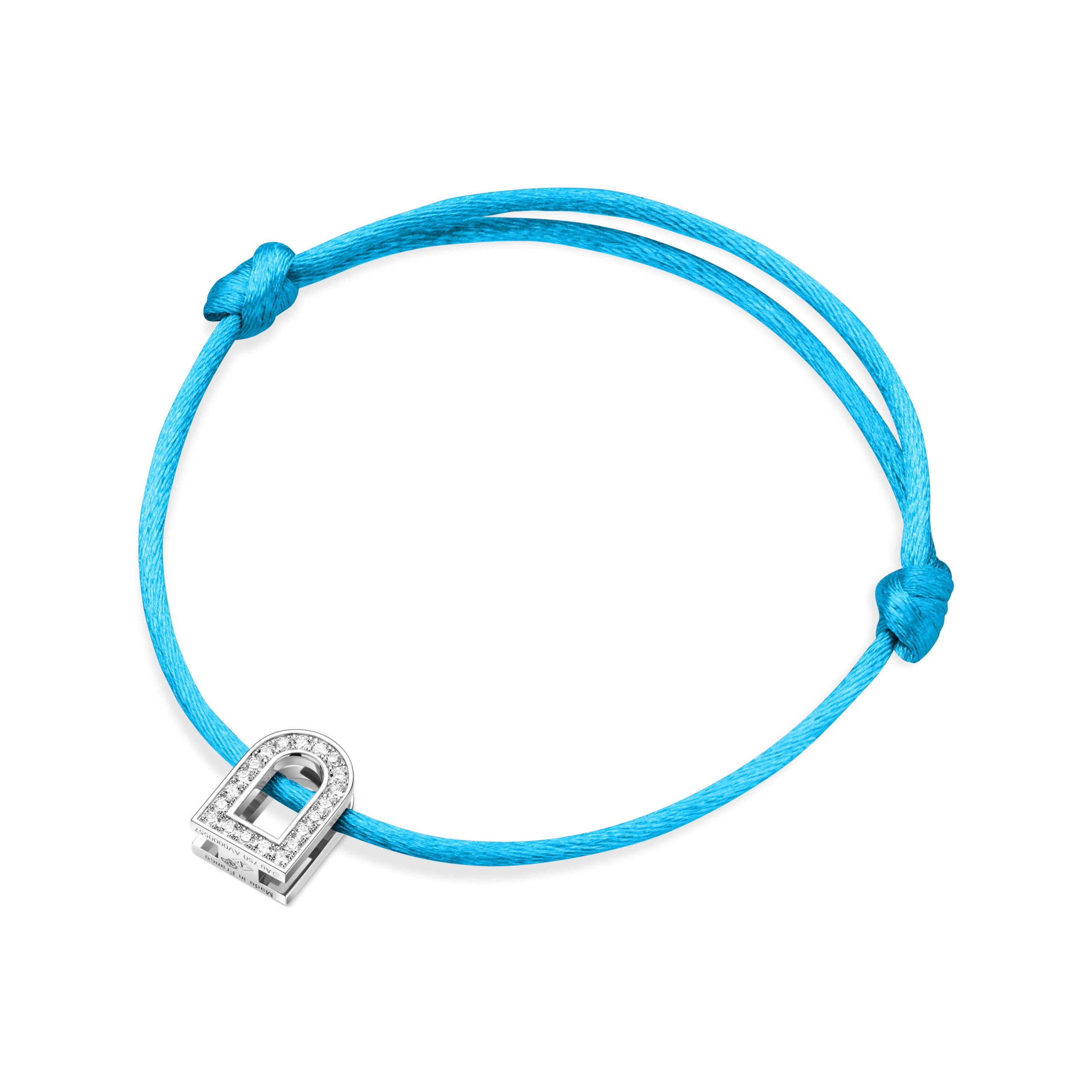 The L'Arc Voyage Charm PM is a turquoise silk cord bracelet adorned with an 18k white gold padlock charm encrusted with Galerie Diamonds, designed by Paris Atelier. It features secure knots that contribute to its elegant yet minimalist appeal.