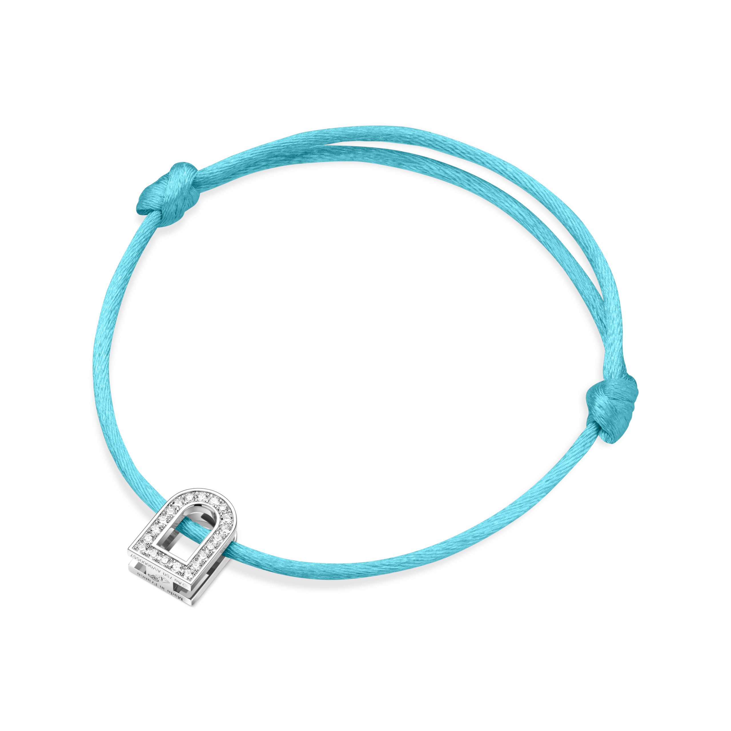 Introducing the L'Arc Voyage Charm PM bracelet from Paris Atelier, featuring a silk cord in vibrant turquoise. At its center is an elegant 18k white gold padlock charm adorned with Galerie diamonds, perfectly highlighted by the simple knots tying the cord.