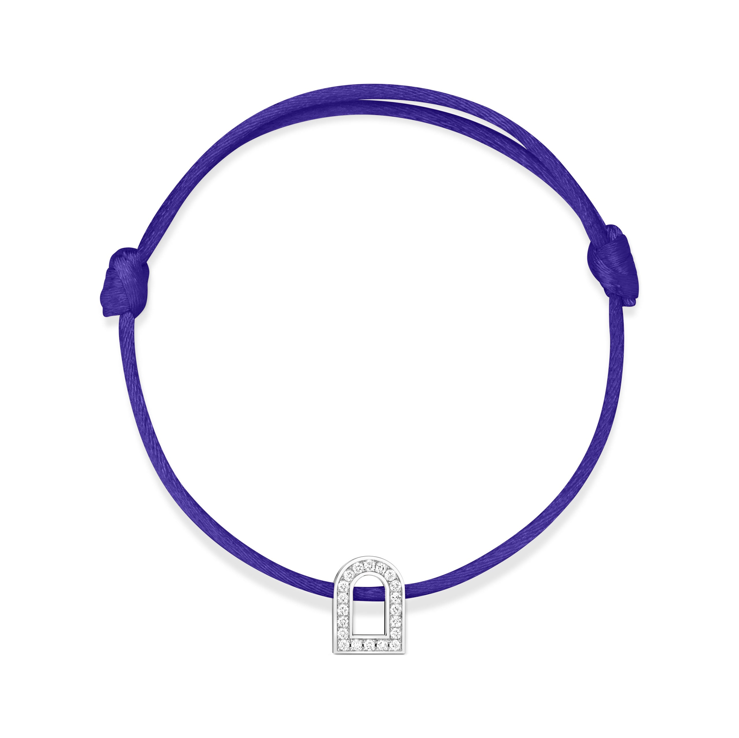 The L'Arc Voyage Charm PM from the Paris Atelier collection features a royal blue silk cord and a small, white gold charm embellished with Galerie diamonds. This bracelet includes adjustable knots for customized sizing.