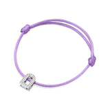 This exquisite L'Arc Voyage Charm PM bracelet from the Paris Atelier is crafted in 18k white gold and embellished with Galerie diamonds, reminiscent of a delicate lock. It graces a light purple silk cord and features two adjustable knots for effortless size adjustment, seamlessly combining elegance with practicality.