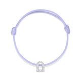 Introducing the L'Arc Voyage Charm PM, an exquisite piece from Paris Atelier. This bracelet features a delicate silk cord in light purple, adorned with an 18k white gold arch-shaped charm embellished with sparkling Galerie diamonds. It also includes adjustable knots on each side for a perfect fit.