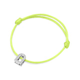 A bracelet with a silk cord in neon green tied in two adjustable knots, featuring the L'Arc Voyage Charm PM crafted from 18k white gold with Galerie diamonds.