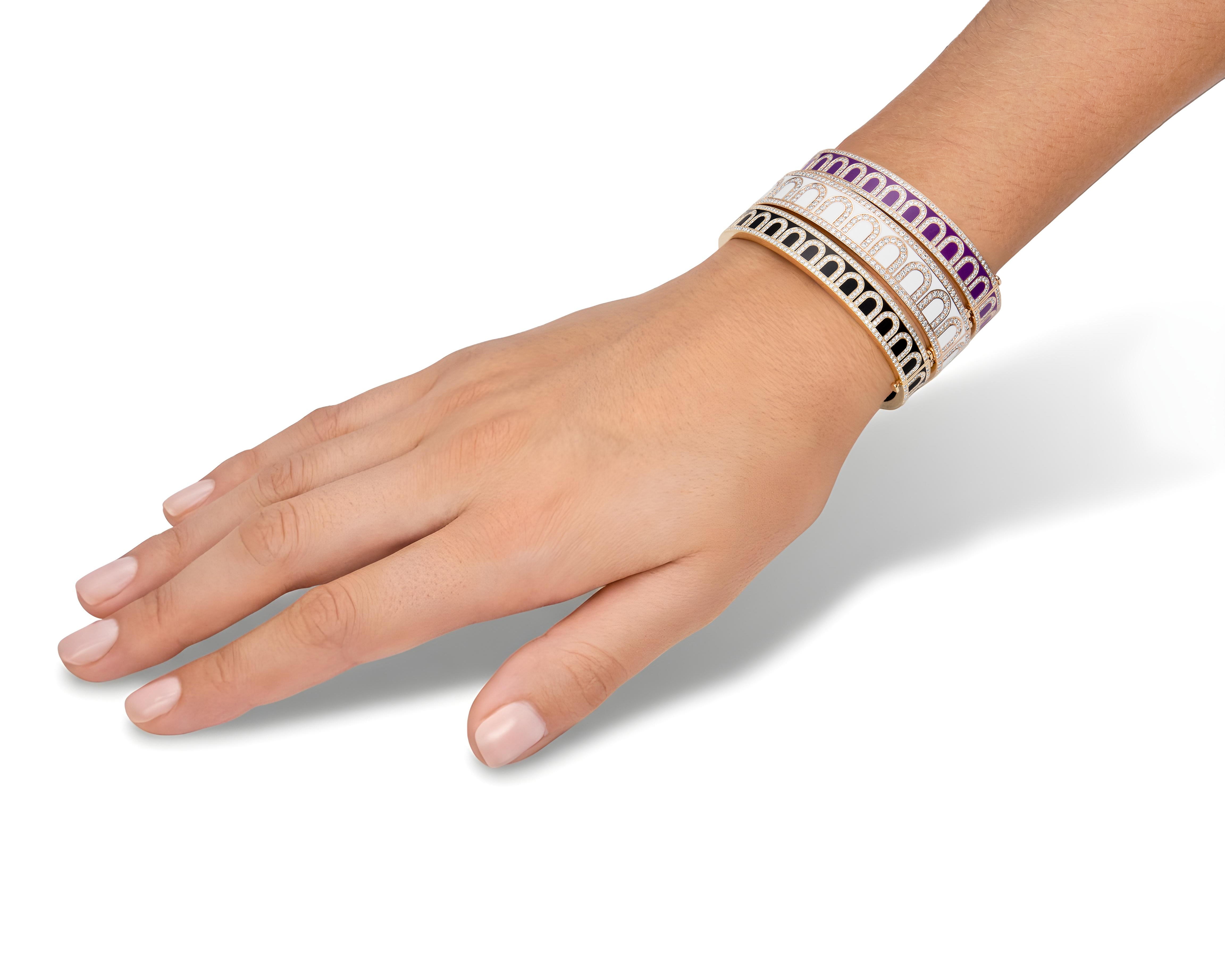 A hand displays four handcrafted enamel bangles—purple, white, blush pink, and black—stacked with the L'Arc de DAVIDOR Bangle GM in 18k Rose Gold with Lacquered Ceramic and Palais Diamonds, set against a white background.