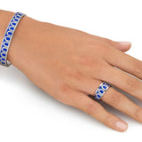 A hand wears the L'Arc de DAVIDOR Bangle MM in 18k white gold with lacquered ceramic and Palais Diamonds, paired with a matching ring, elegantly displayed on a white background.